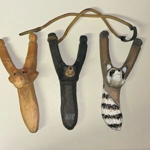 3 carved wooden animal sling shots